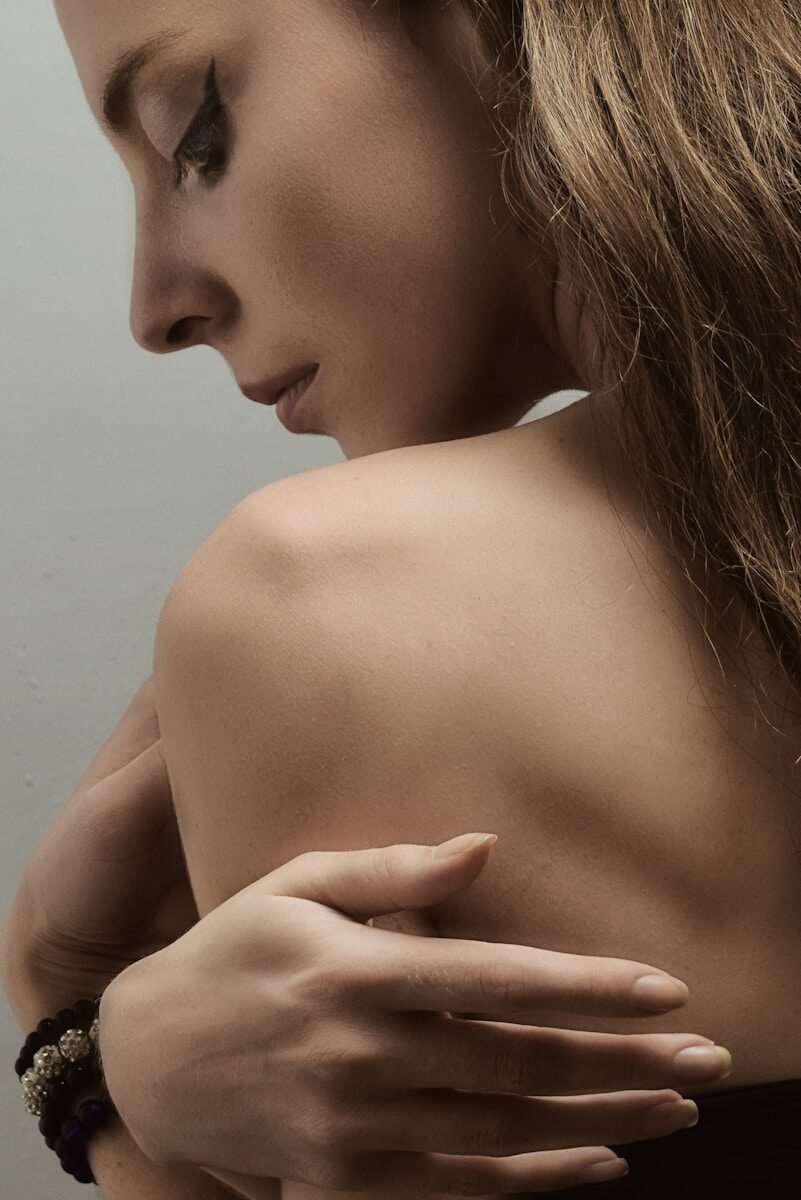 a woman with her arm around her shoulder