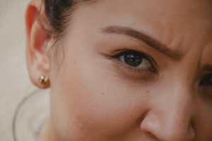 a close up of a woman's face - learning more about eyelid surgery