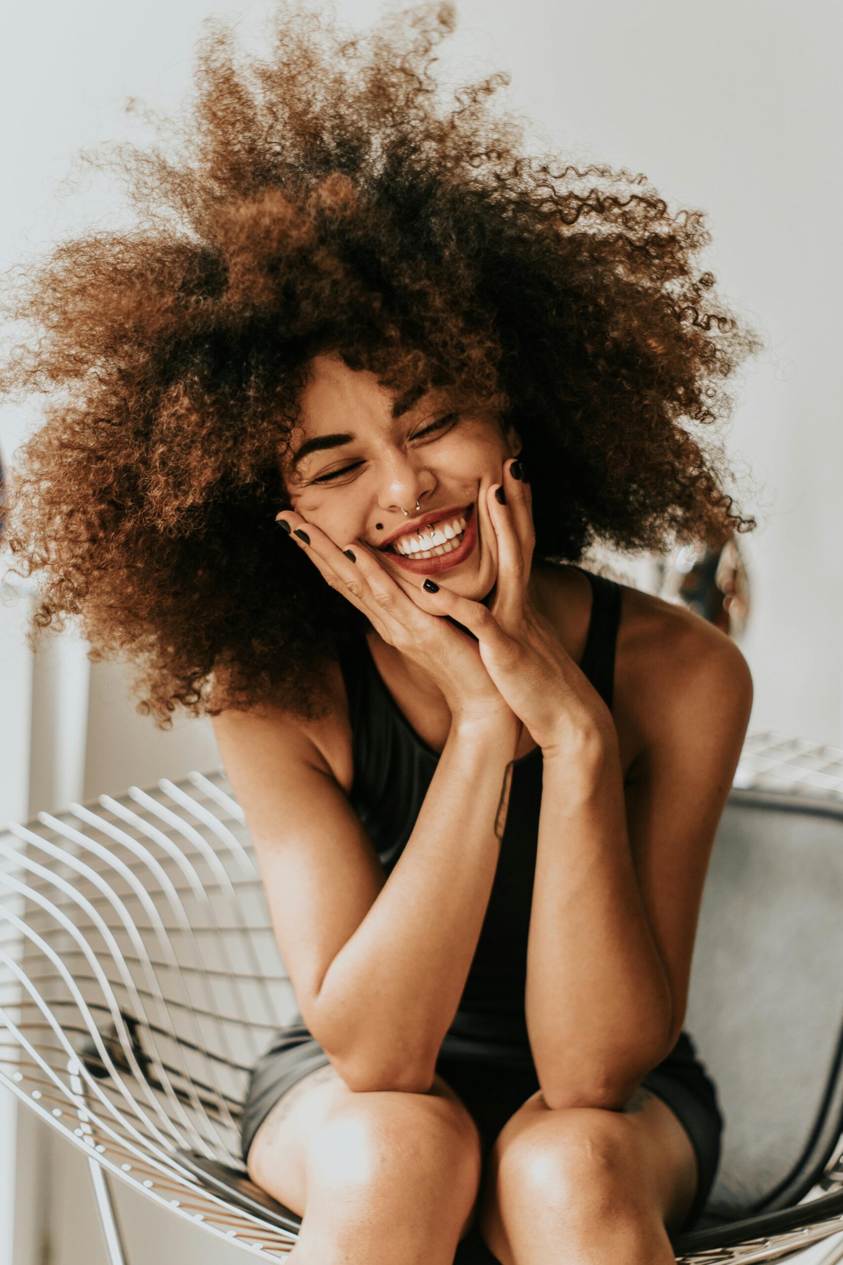brlander_3 Confident woman stands in the wind, laughing as her hair blows around her face